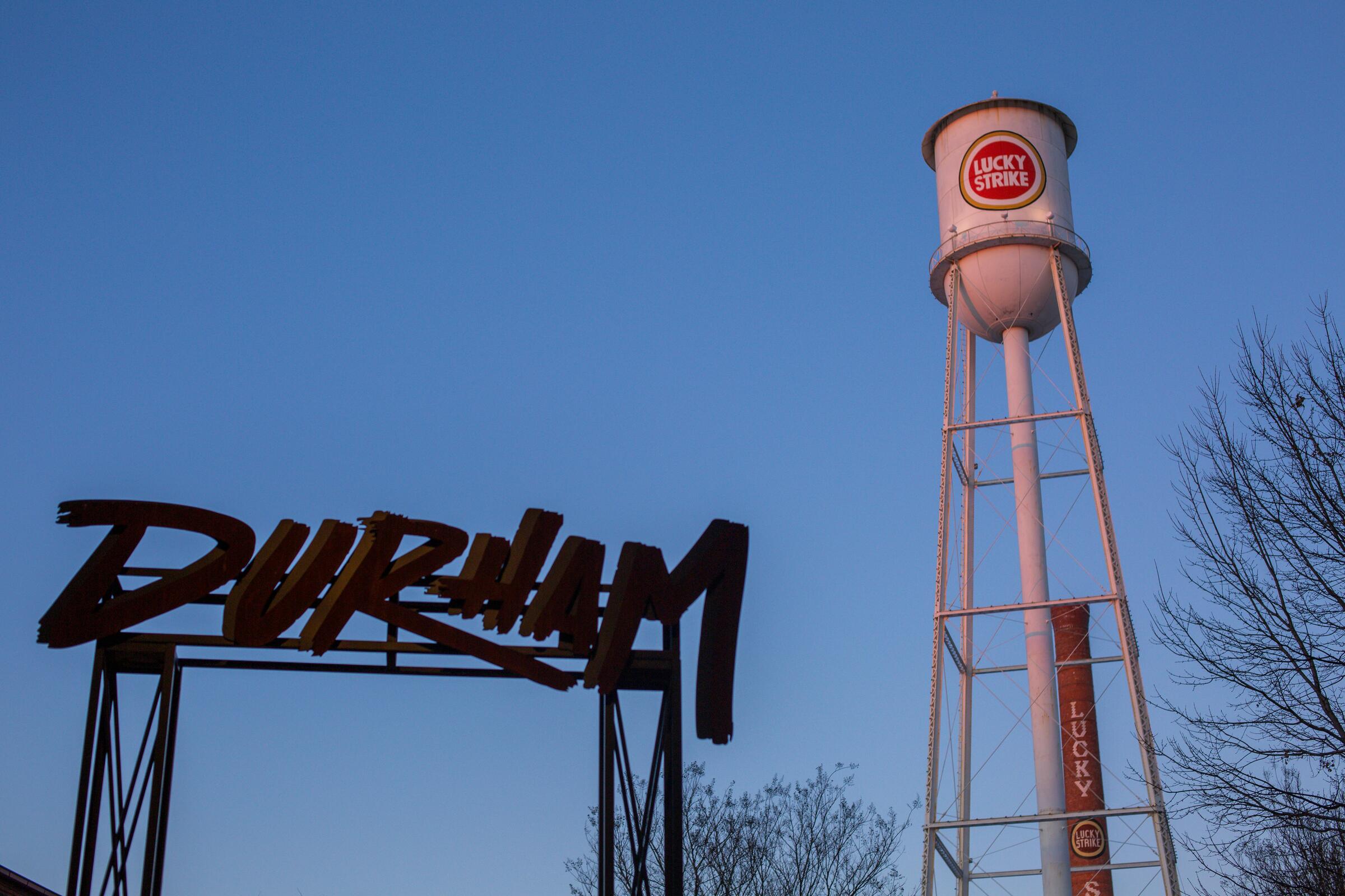 The Durham sign and Lucky Strike water tower against a blue sky