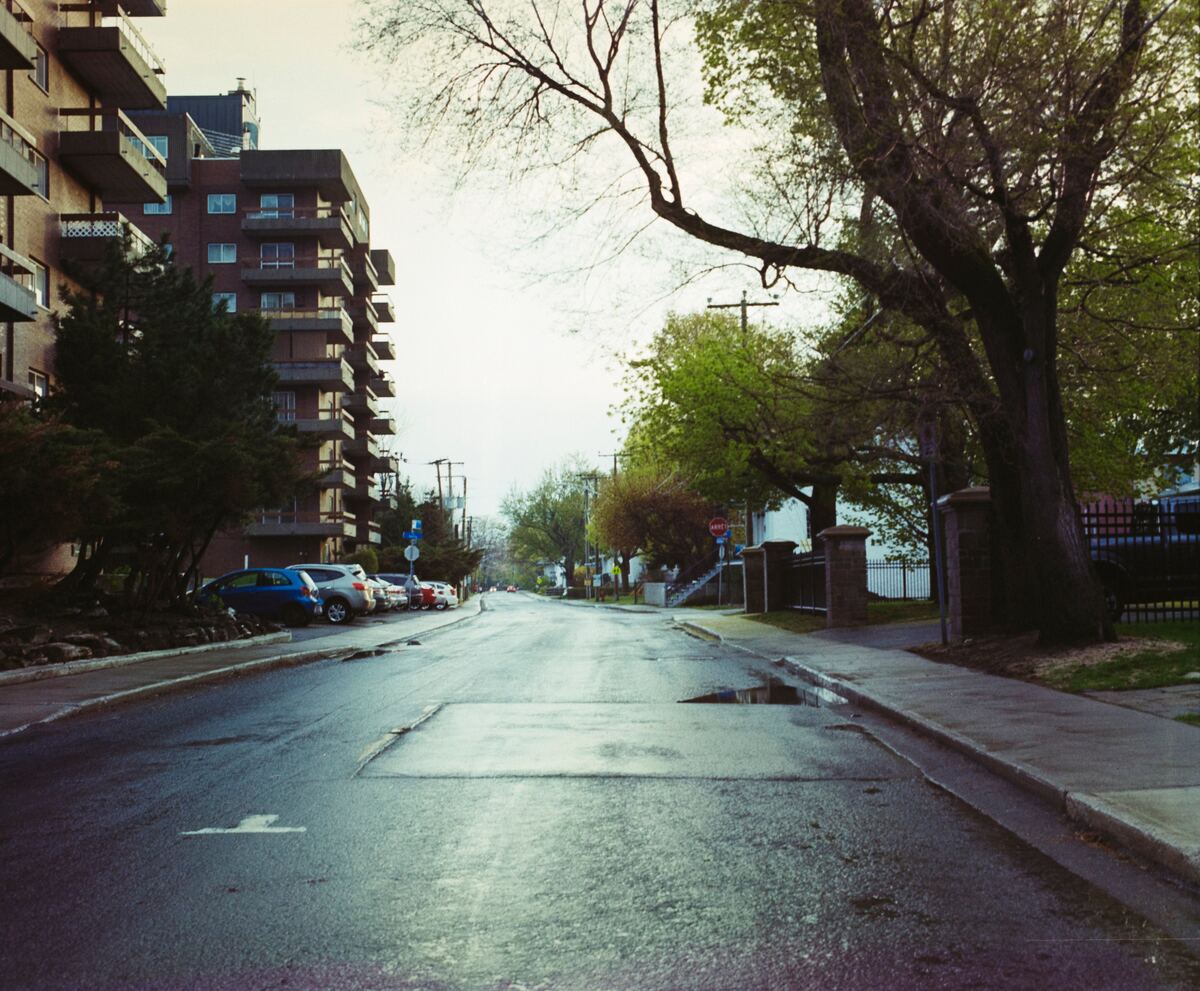 A quiet residential street of apartment buildings at dusk